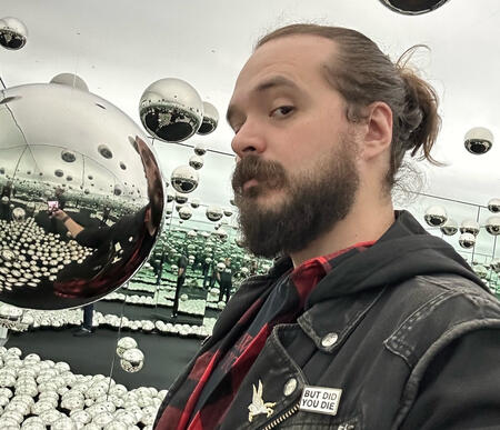 A picture of me, Wren, with a bunch of reflective orbs and mirrors all around.